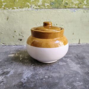 Closed brown white ceramic jar for pickles spices home decor side view