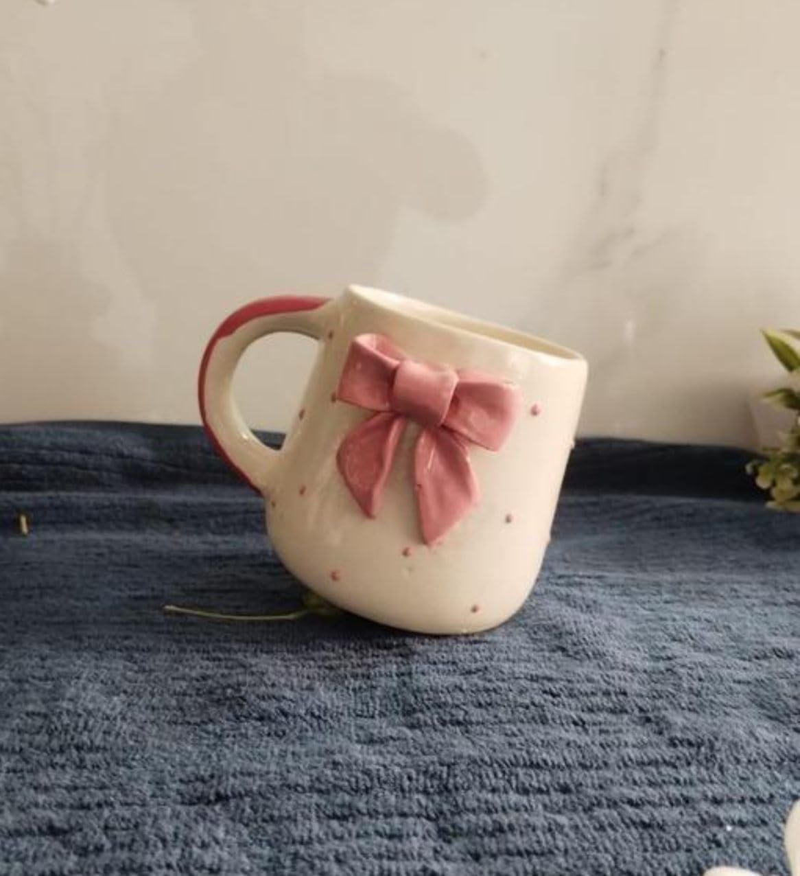 Ceramic bow mug dimensions showing 10 cm height and 7 cm mouth diameter